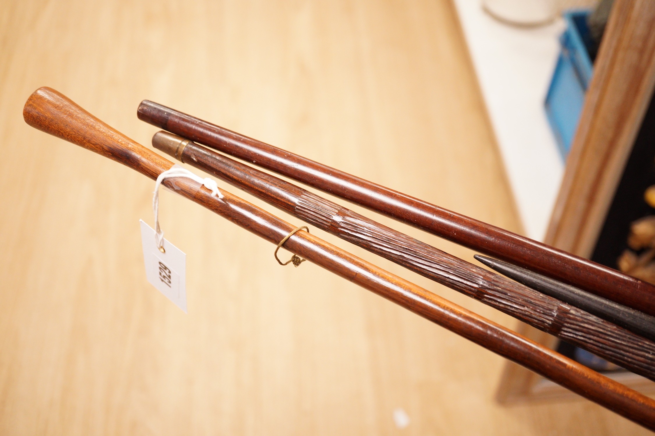 Two various hardwood canes, an ebony spear and a horn tool, longest 111cm